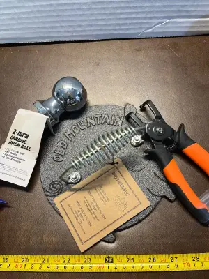 Truper combination circlip pliers , 2in hitch ball & old mountain pig bacon press