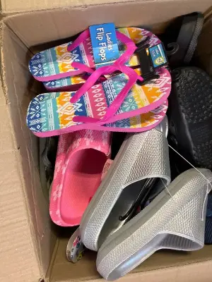 big box of different size slip on shoes