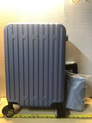 Blue luggage on wheels with toiletries bags and cup holder on back