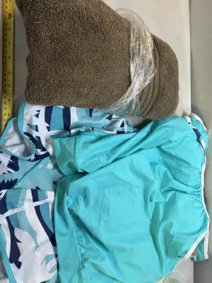 medium swimsuit and brown towel
