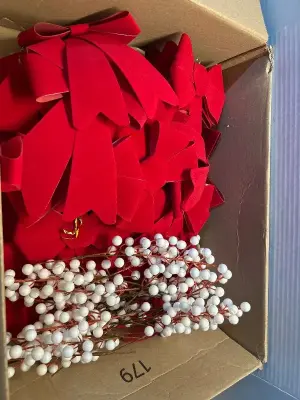 Box of felt ribbons and white artificial berries decorations