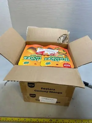 three boxes of eight bags of Amos gummy mango peeler’s candy