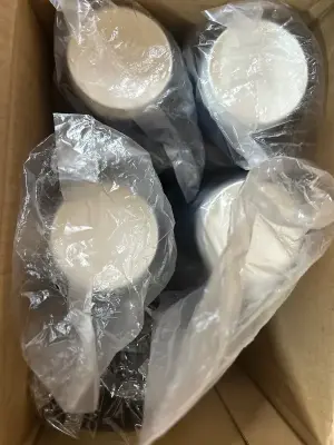 A lot of disposable cups with lids and straws
