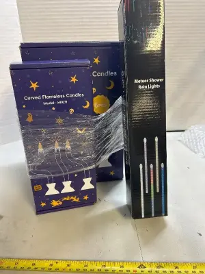three boxes of curved flameless candles, one box of meteor shower, rain lights