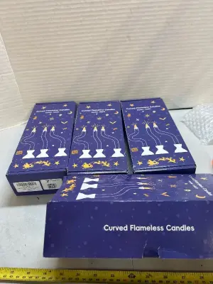 four boxes of curved flameless, fake candles
