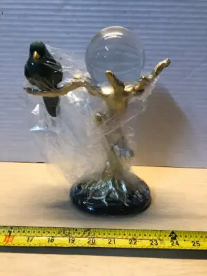 Bird on a branch with clear ball