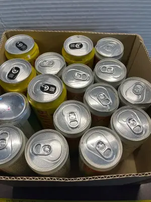 box of various can drinks (mostly in date)
