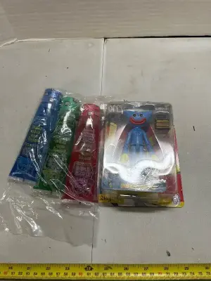 three pack of ooze tube candies and one poppy playtime, smiling huggy Wuggy figurine
