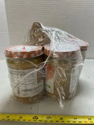 four jars of Smuckers peanut butter chunky