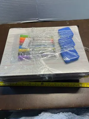 large bundle of boards with line colored markers and erasers