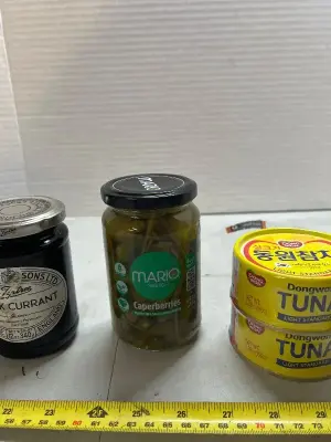 Black current preserve jar of caper berries, two cans of tuna