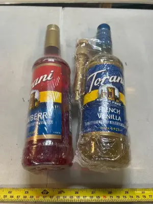two bottles of torani 25.4 fluid ounce strawberry syrup and French vanilla