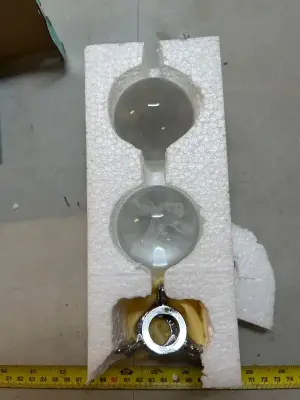 Two glass balls, one depicts axolotl both have stands