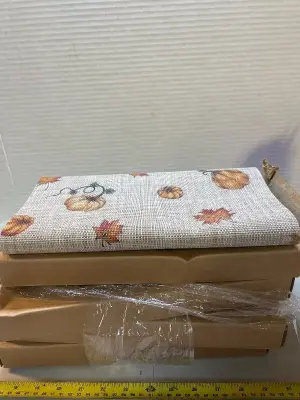 four boxes of Thanksgiving table runners