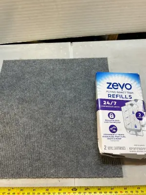 two pack of refill cartridges for Zevo flying insect trap one peel and stick sound dampening pad