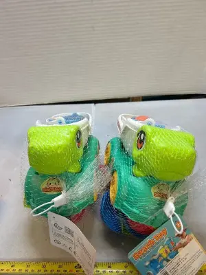 two sets of dinosaur beach toys