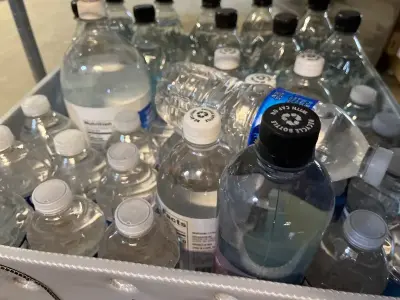 crate of various water bottles