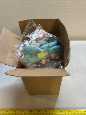 box of miniature babies in animal outfits