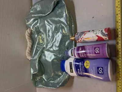 bag with two things of sunscreen and fragrance mist