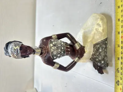 African woman statue missing earring