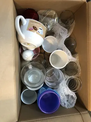 Box of different glasses and cups