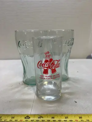 2 coca-Cola glasses 1 of the tall ones broke