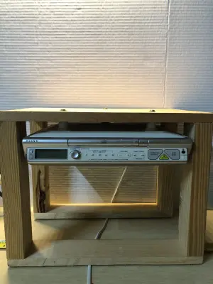 Under cabinet radio cd player screwed to wooden frame works