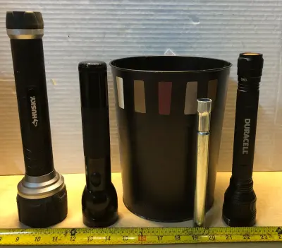 Small metal waste basket , husky flash light, mag lite flashlight, Duracell flashlight , extension rod