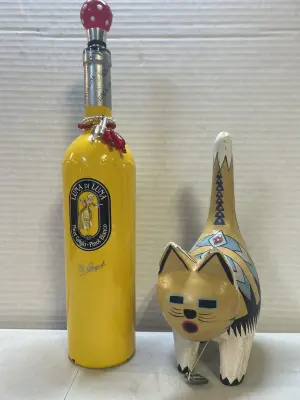 decorative wine bottle with stuffer and wooden cat