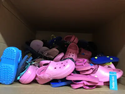 Box of assorted kids shoes different sizes