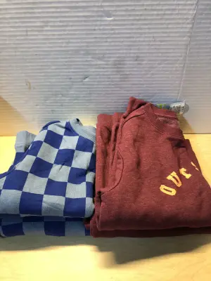 2 kids size large shirts, one Xs, one medium