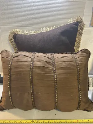 2 brown and gold throw pillows