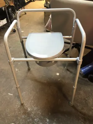 Folding bedside commode
