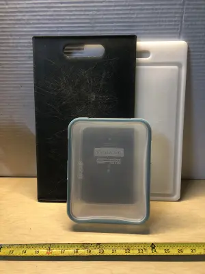 Storage container with 2 used cutting boards