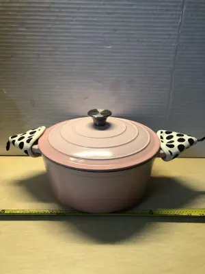 Taimasi pink Dutch oven used with oven mits