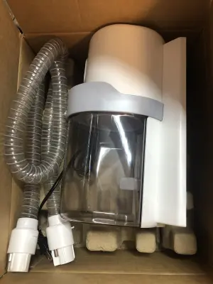 Pet grooming kit and vacuum attachments in bottom of box works