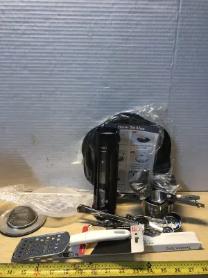 Kitchen supply lot measuring cups, grater, 2 sink strainer, tongs, meat shredder, coffee pod holder
