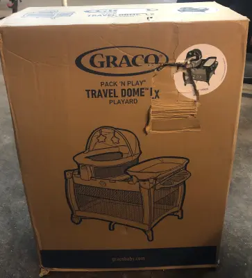 Graco pack and play travel dome lx playpen has cut on bed from box cutter as is