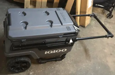 Large used Igloo cooler on wheels with retractable handle